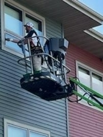 Commercial window cleaning on lift — Pope's Window Cleaning Wisconsin